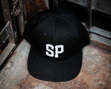 Load image into Gallery viewer, black suavecito hat with white embroidered text &quot;SP&quot;
