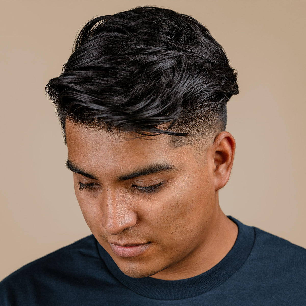 Man with hair styled with Firme Clay Pomade