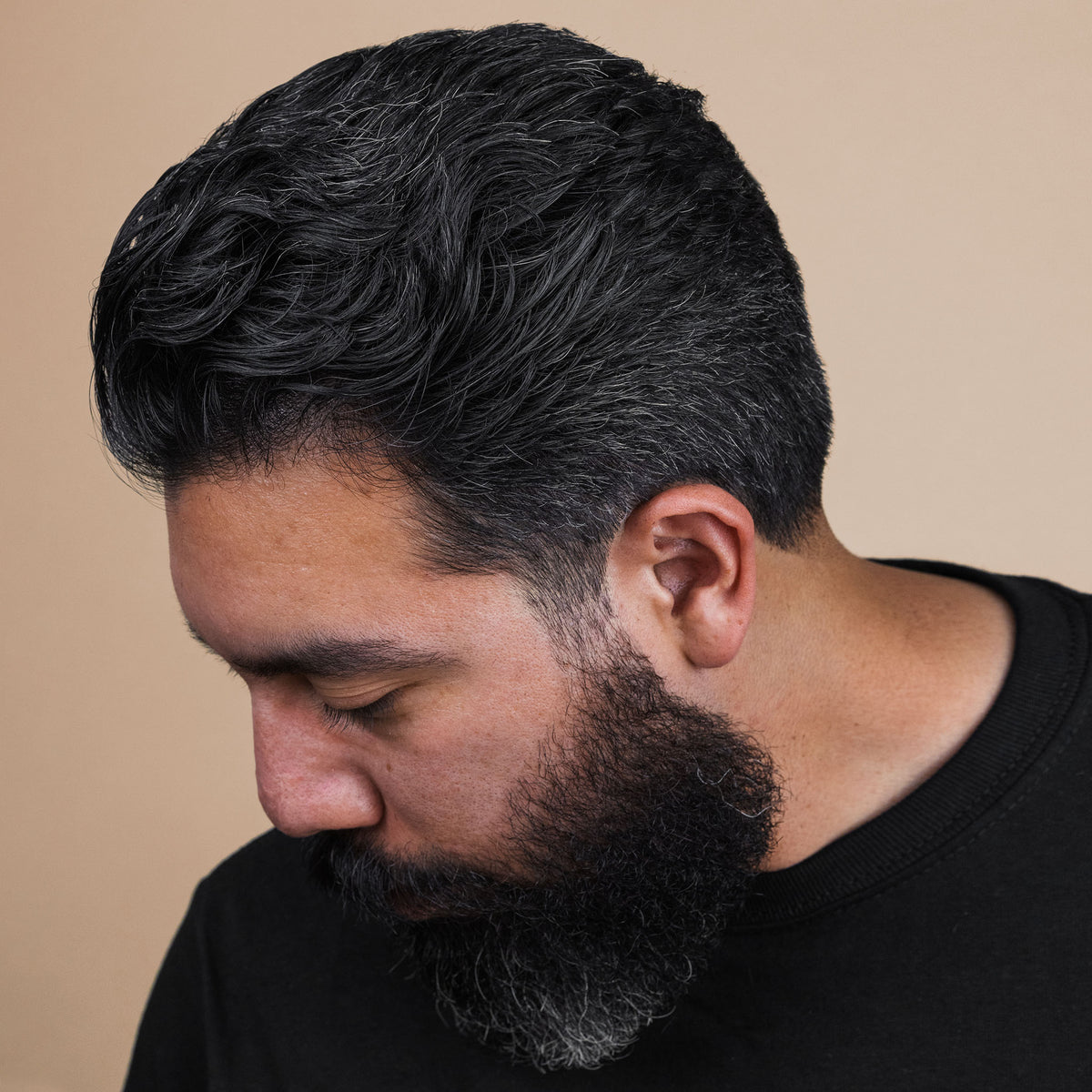 Man with hair styled with Firme Clay Pomade