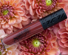Fortitude lipgrip tube on pink flowers