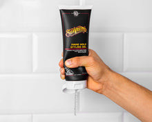 Hand holding the Firme Hold Styling Gel
