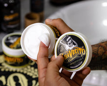 Suavecito Hybrid Pomade scooped out of jar