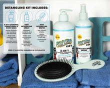 Suavecito Kids detangling kit with shampoo, 3-in-1 wash, detangling spray, and brush on a blue towel.