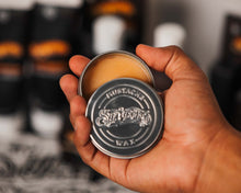 Mustache Wax Whiskey Bar Fragrance, open tin container in hand 