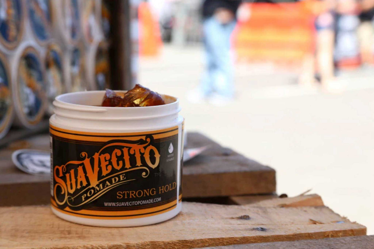 Open Suavecito pomade container resting outside