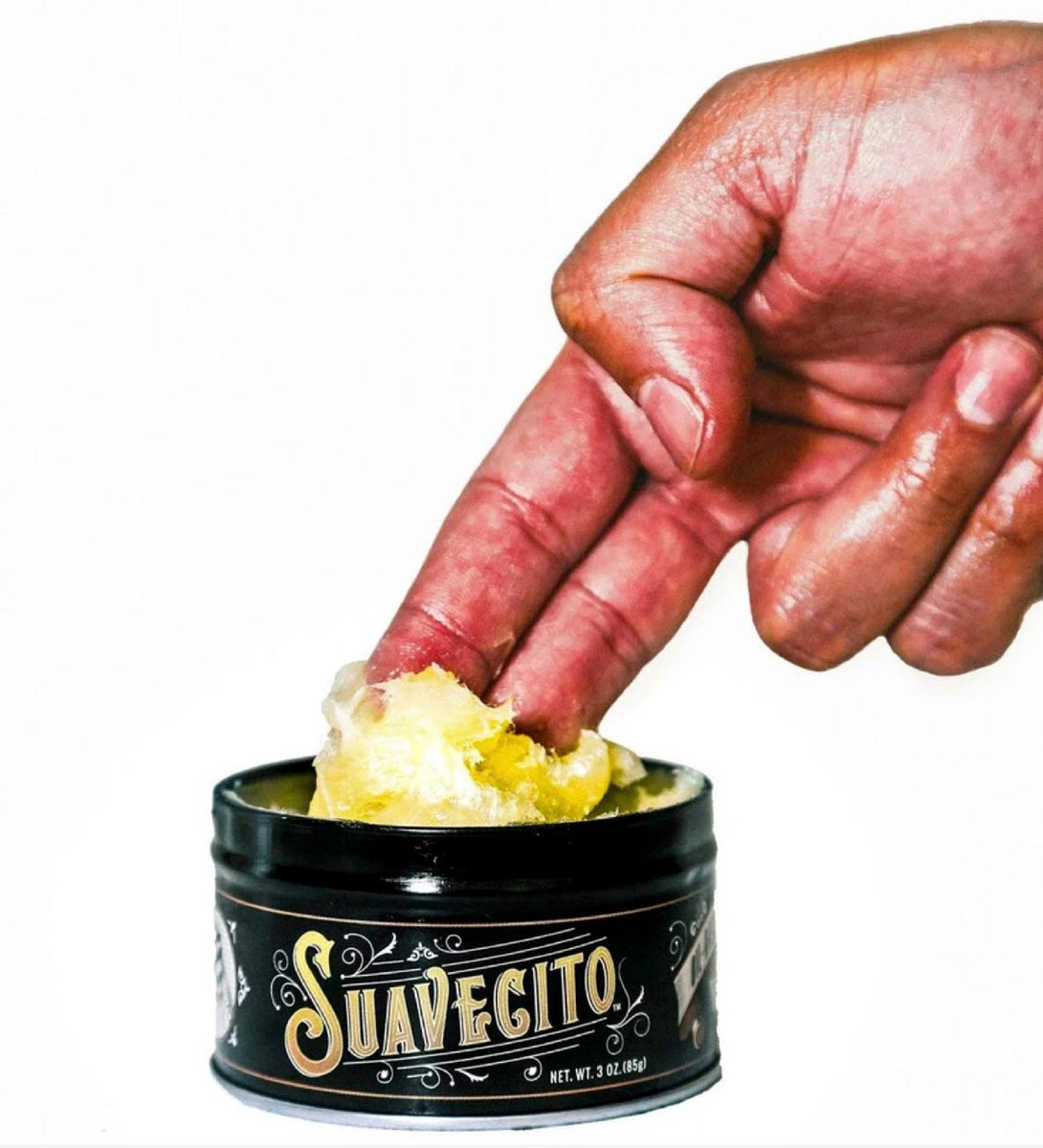 Two fingers scooping oil based pomade
