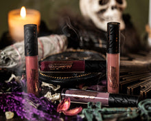 Spellbound collection lipgrips on table with spooky props