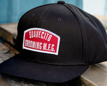 Load image into Gallery viewer, suavecito hat with embroidered text and red background &quot;suavecito grooming m.f.g.&quot;
