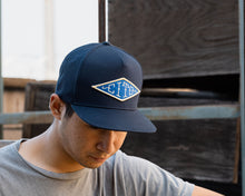 Load image into Gallery viewer, man wearing - blue suavecito hat with white embroidered text and blue background &quot;cito&quot; in diamond shape
